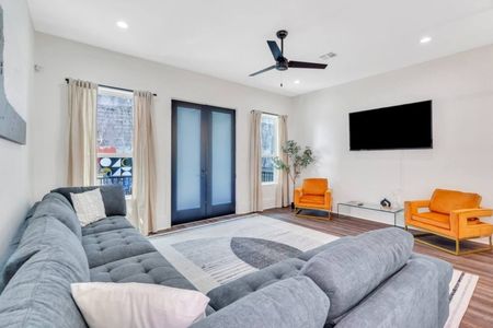 Laid-back living room w/ smart TV, blue accent wall & comfy seating for all.