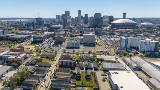 Sweeping aerial view of the vibrant neighborhood & city beyond.