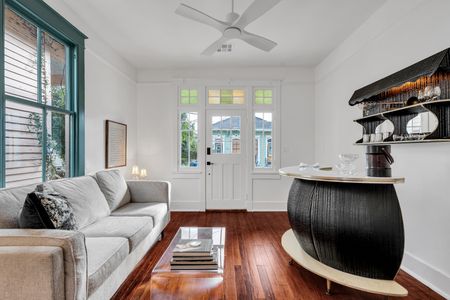 Airy living area w/ bar seating & sunlit French doors that open up the whole space.