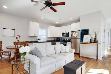 Airy living room w/ a comfy couch — light, white & made for lounging.