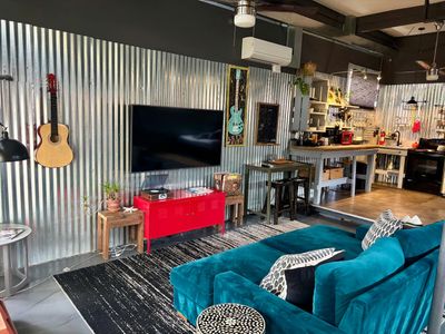 Industrial-cool living space w/ a warm, lived-in vibe — unwind & recharge.