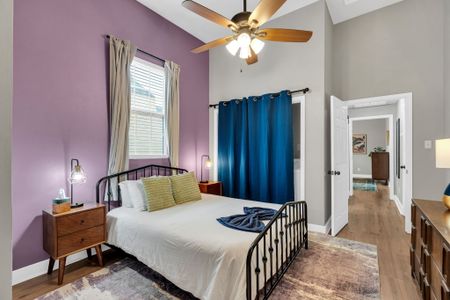 Cheerful bedroom w/ a bed, teal curtains & colorful accents for a lively stay.