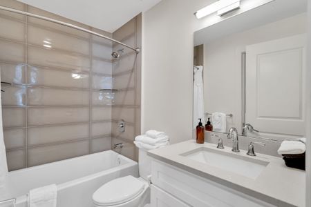 Clean and bright with sleek finishes, this bathroom offers a full tub/shower combo, fresh towels, and all the essentials for a relaxing stay.