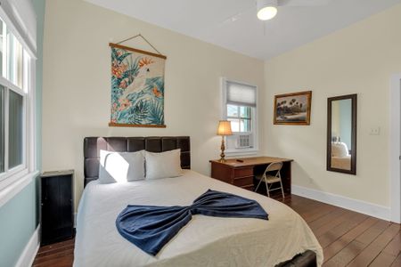 Cozy bedroom w/ a plush bed, local artwork & a quiet, restful atmosphere.