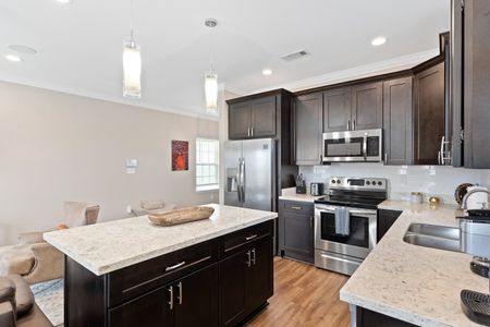Sleek kitchen w/ stainless steel appliances & plenty of counter space to cook up a feast.
