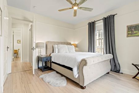 Cozy bedroom w/ a neatly made bed & soft lighting.