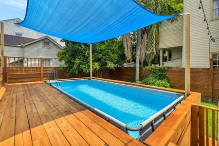 Sparkling outdoor pool on a spacious wooden deck — your private backyard escape.