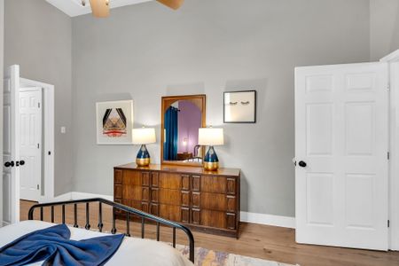 Warm wood dresser w/ eclectic art — a charming corner that feels curated & personal.