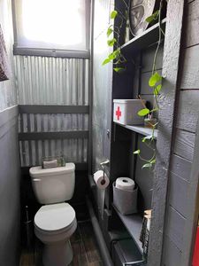 Private commode tucked into a clean, well-designed space.