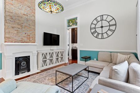 Airy living room w/ a Smart TV & classic white fireplace for relaxed evenings in.