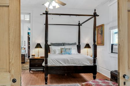 Spacious four-poster primary bedroom w/ elegant details throughout.