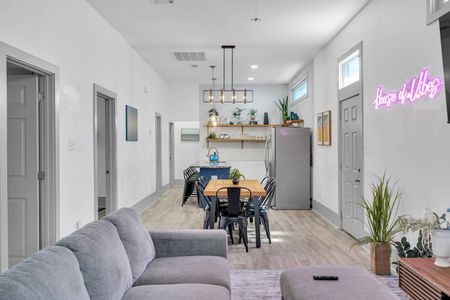 Open-concept dining area w/ modern pendant lighting — perfect for gathering around a meal.