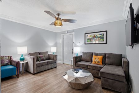 Relaxed living area w/ ceiling fan & warm seating for easy downtime.