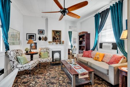 Warm living room w/ eclectic charm flowing into the outdoor space.