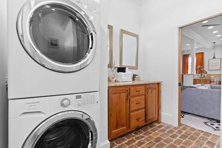 Stacked washer & dryer tucked in neatly — pack light & freshen up anytime.