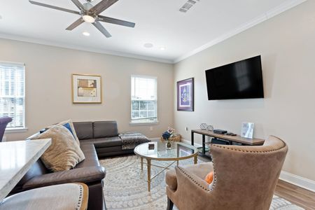 Bright living room w/ cozy seating & a wall-mounted TV for all your streaming nights in.