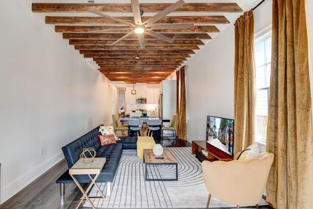 Soaring exposed wood beams give this historic home its unmistakable New Orleans soul.
