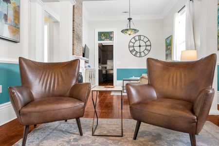 Leather armchairs bathed in warm light — sink in & unwind.