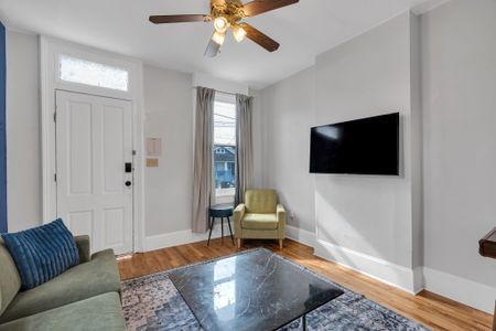 Relaxed living area w/ a wall-mounted smart TV for cozy nights in.