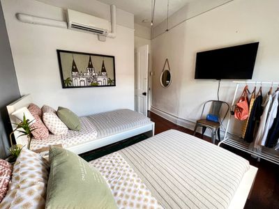 Bright, airy bedroom w/ a plush bed & clean, understated decor.