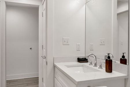 Bright vanity w/ sink & ample counter space to ease your morning routine.