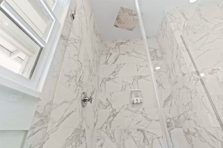 Elegant marble-look tile detail adding a luxe touch to the bathroom.