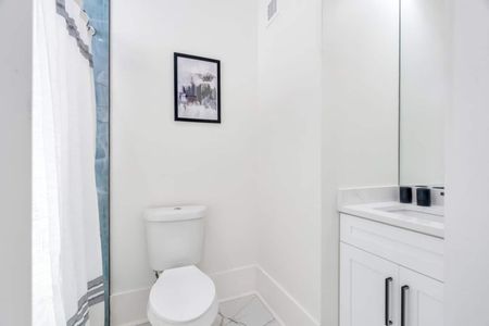 Upstairs full bathroom w/ double sink vanity & modern black accents.
