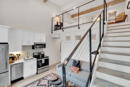 Open loft layout blending kitchen, lounge & sleeping areas in one stylish space.