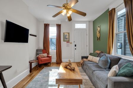 Inviting living room w/ warm tones & comfortable seating — kick back & unwind.