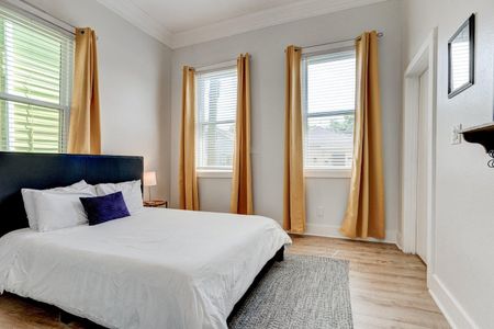 Bright queen bedroom w/ natural light & warm tones — a cozy first bedroom to recharge.