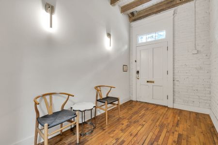 Welcoming entryway with historic charm and cozy seating—your New Orleans stay starts here.