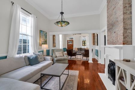 Bright, airy living room w/ hardwood floors & eclectic décor — perfect for gathering after a day out.