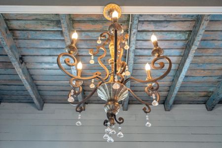 Ornate vintage chandelier dripping w/ Southern charm & character.