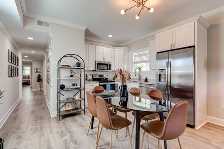 Sleek kitchen & dining area w/ a stylish table perfect for casual meals.