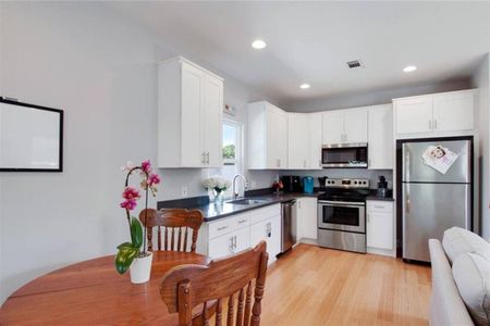 Dining area w/ a view into the kitchen — ideal for easy meals together.