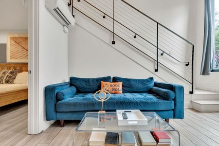 Statement staircase & sleek furniture bring contemporary charm to the main area.