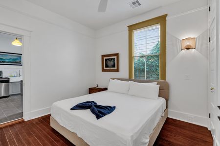 Serene bedroom w/ natural window light & crisp, clean linens.