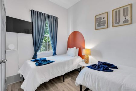 Vibrant bedroom w/ a statement headboard, soft bedding, & a warm bedside glow.