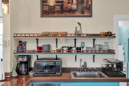 Well-stocked open shelving kitchen w/ everything you need within reach.