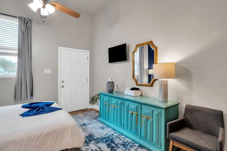 Teal entryway console w/ a mirror & warm lamp — a stylish first impression.