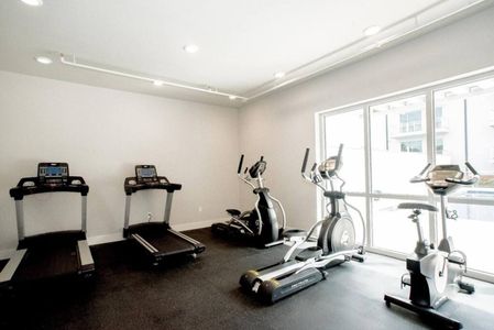 Bright, open fitness room w/ natural light & modern equipment.