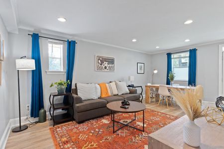 Cozy living & dining area w/ warm tones, perfect for gathering after a long day.