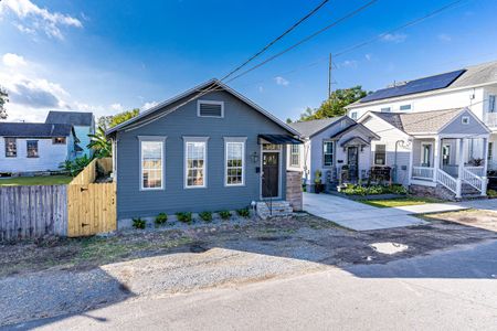 Charming blue cottage exterior w/ great curb appeal — a true Uptown gem.