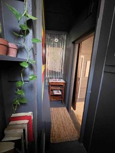 Lush greenery adds a refreshing touch to the bathroom's industrial aesthetic.