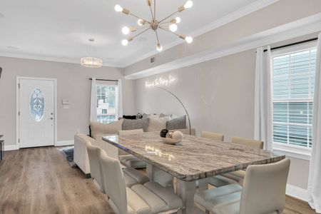 Bright dining area w/ marble-top table, perfect for sharing meals together.