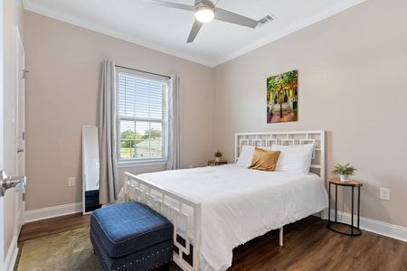 Airy queen bedroom w/ golden accents & natural light to wake up refreshed.