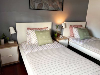 Soft, inviting bed dressed in light linens — a calm corner to recharge.