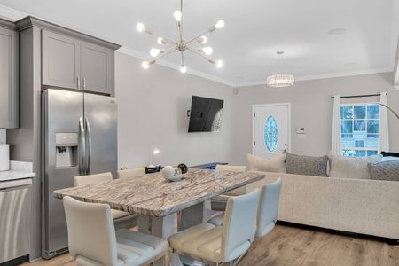 Open dining & kitchen area w/ modern finishes & plenty of seating.