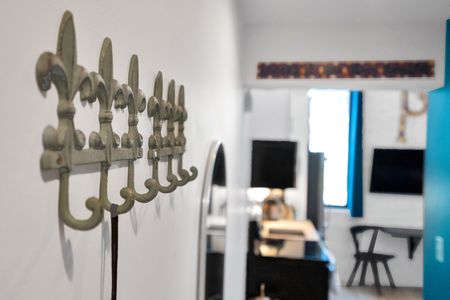 Vintage brass hooks mounted on a teal wall — stylish & practical for everyday use.