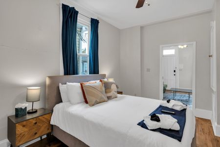 Bedroom w/ plush bedding & layered pillows for a restful night's sleep.